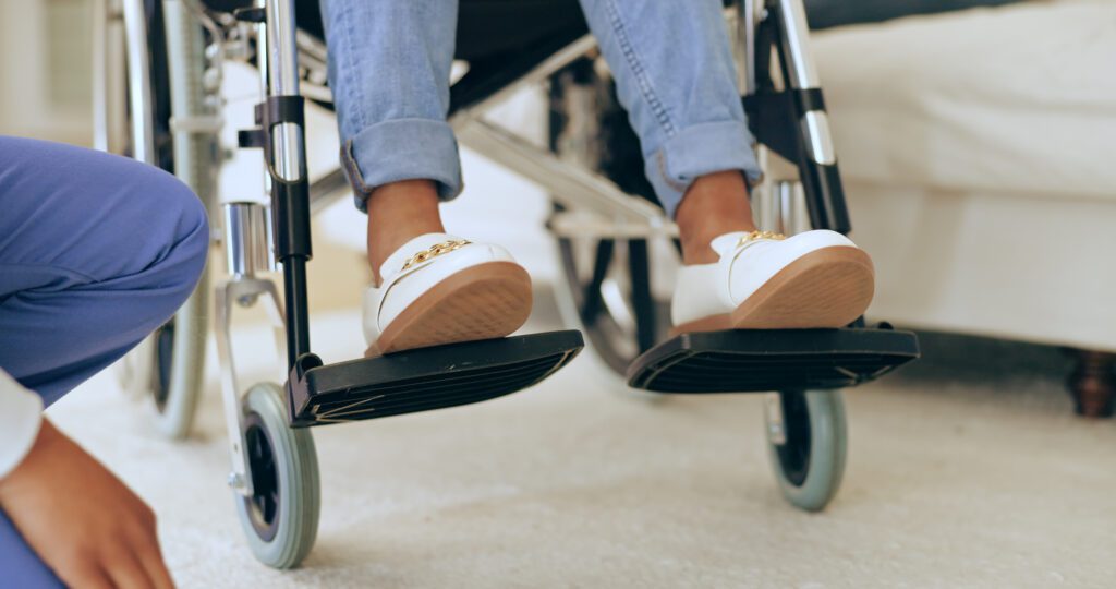 Bottom half view of someone in a wheelchair in a care home or hospital